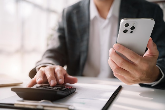 Hand businessman doing finances and calculate on desk about cost at office