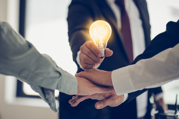 Photo hand of businessman holding light bulb as symbol of success idea