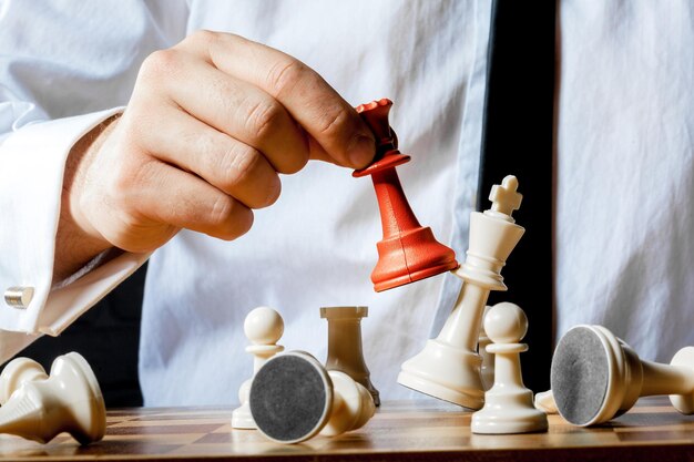 Hand of businessman playing chess