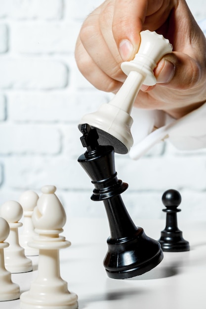 Hand of businessman playing chess