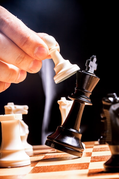 Hand of businessman playing chess