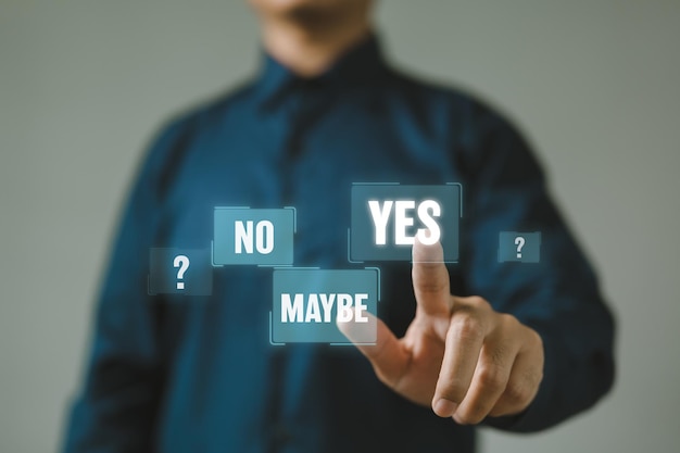 The hand of a businessman presses the Yes button symbolizing the concept of decisionmaking and affirming a choice or course of action