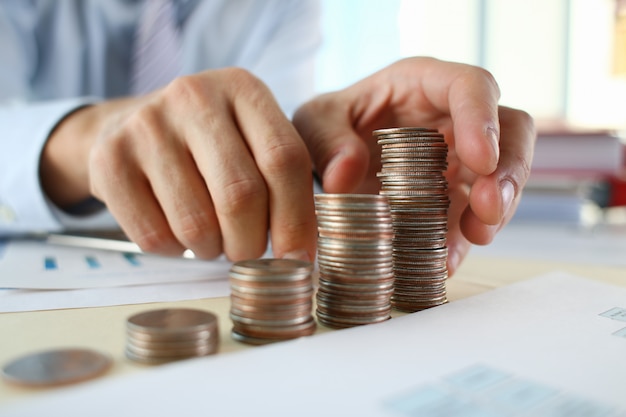 Hand businessman putting pin money