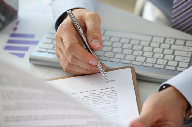 Hand of businessman in suit filling and