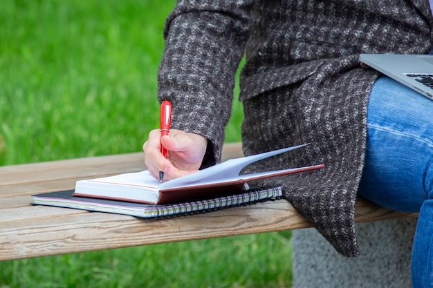 Hand businessman working with documents on a street bench