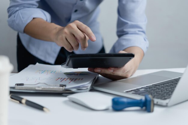 Photo hand businessperson doing financial and calculate on desk about cost at home officebusiness investment financing accounting banking tax concept