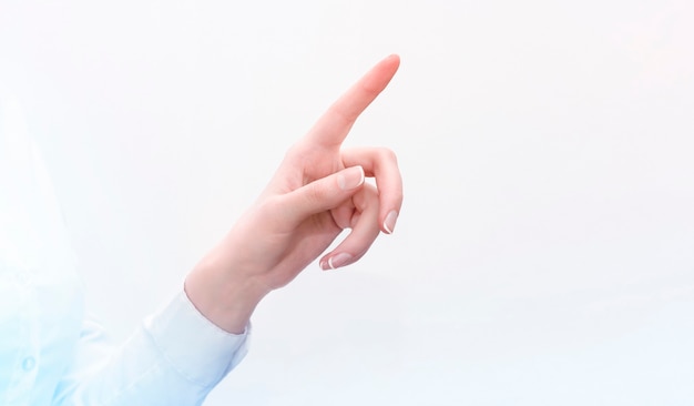 Hand of a businesswoman presses on a transparent screen