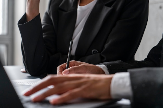 Hand of businesswoman writing in office