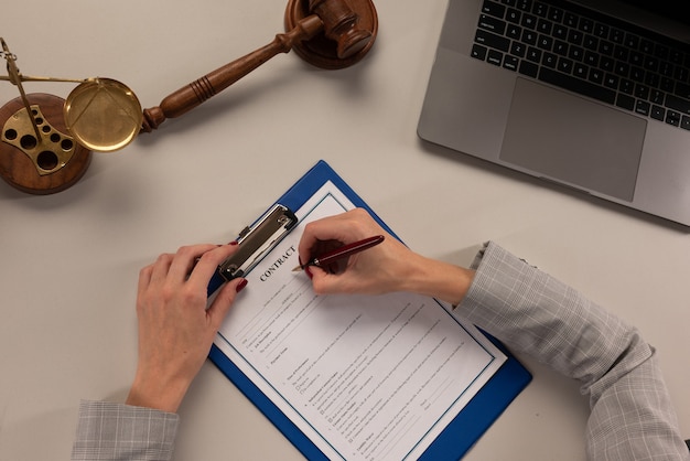 Hand of businesswoman writing on paper in office