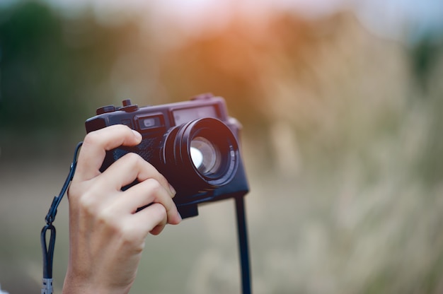 Hand and camera of the photographer Holding and carrying the camera to take pictures