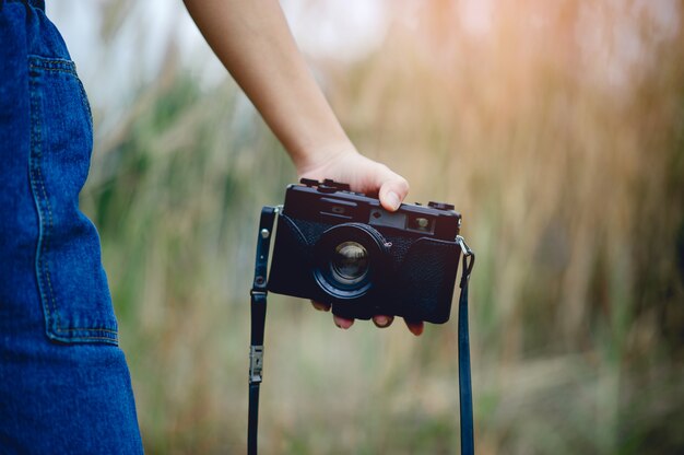 Hand and camera of the photographer Holding and carrying the camera to take pictures