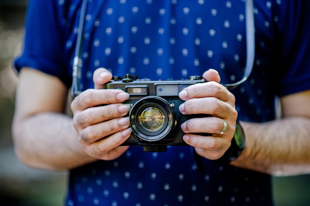 Hand and camera of the photographer Travel in the mountains and nature 