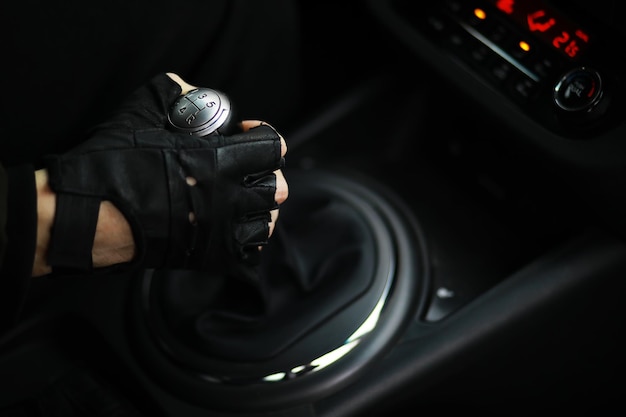 Hand on the car gear knob The driver switches the speed in the car Hand on gear lever