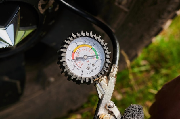 Hand and car wheel add air pressure