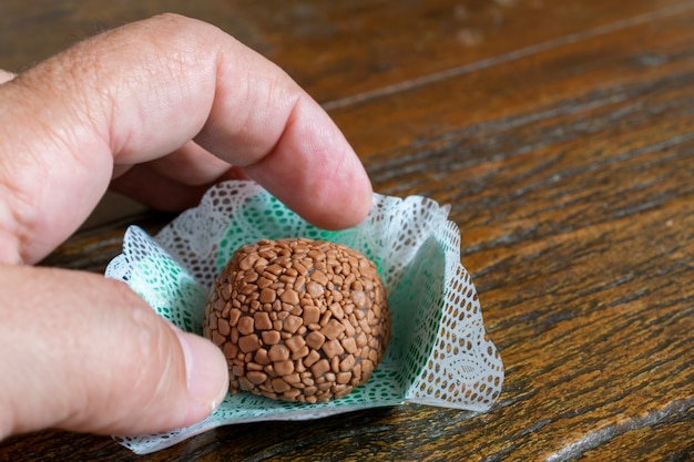 손 잡기 Brigadeiro. 소박한 나무에 수제 초콜릿 봉봉. 브라질 달콤한