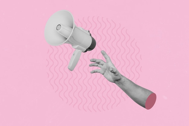 Hand catching a flying loudspeaker on a creative abstract pink background