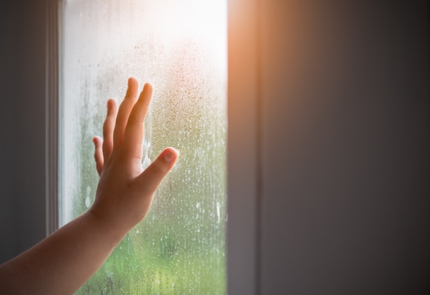 Photo hand child with fogged on the window.