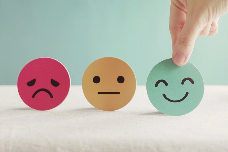 Hand choosing happy face