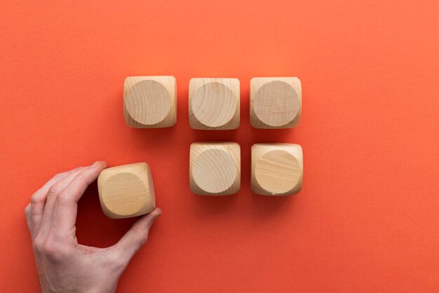 Hand choosing a wooden block from a set Business choice concept