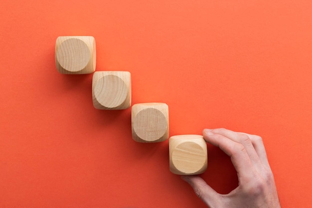 Hand choosing a wooden block from a set Business choice concept