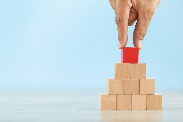 Hand Closer up hands of businessmen,stacking wooden blocks into steps,Concept of business growth success