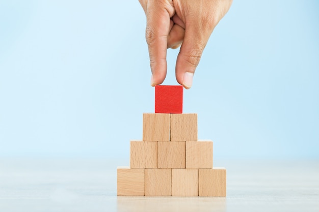 Hand Closer up hands of businessmen,stacking wooden blocks into steps,Concept of business growth success