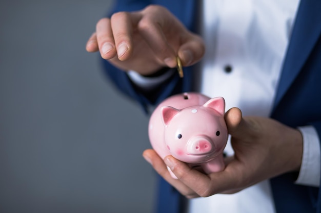 Hand coin with piggy bank