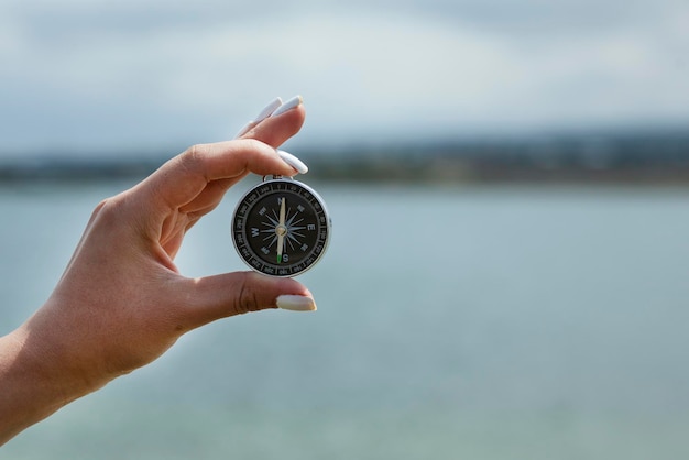 Hand compass in sea background