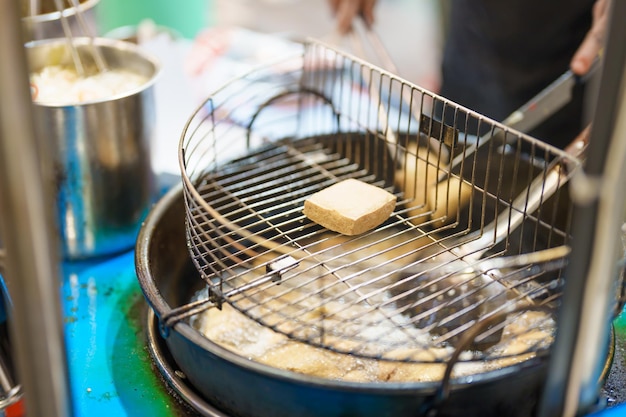 Hand cooking Stinky Tofu at night market famous Taiwanese Street Food of Taiwan exotic food in local market