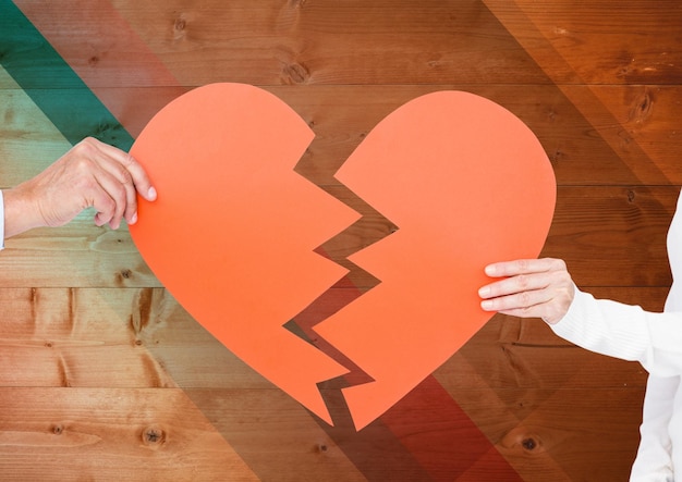 Hand of couple holding broken hearts