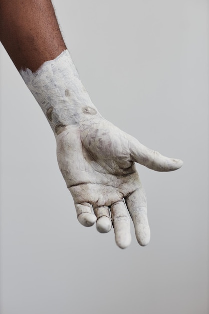 Hand covered in white paint minimal