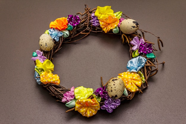 Hand crafted Easter wicker wreath with quail eggs and handmade flowers