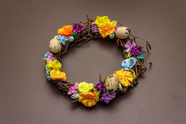 Hand crafted Easter wicker wreath with quail eggs and handmade flowers