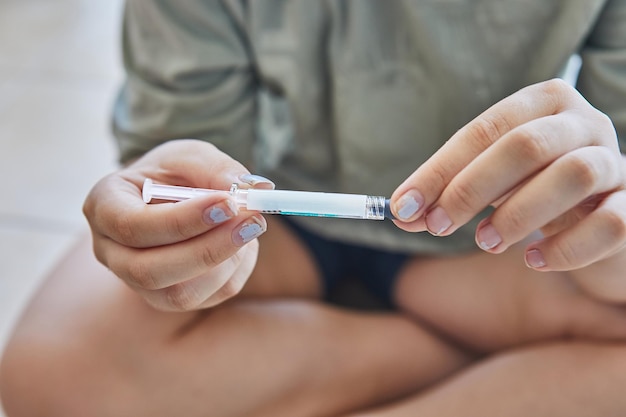 hand cutting medication packaging with scissors