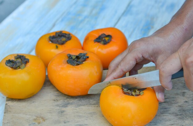 hand on cutting the persimmon