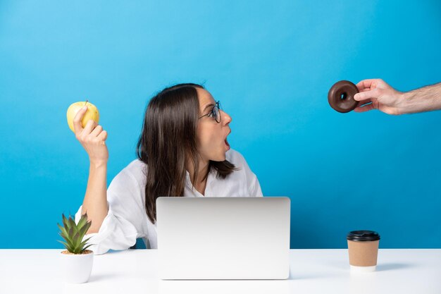 Hand die donut aanbiedt aan Spaanse jonge vrouw