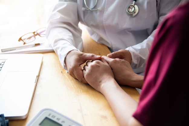 Hand of doctor reassuring her female patient