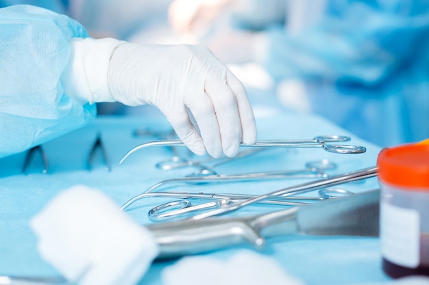 Hand of a doctor taking a scissors