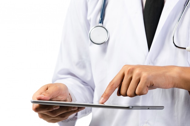 Hand of doctor using tablet computer with stethoscope .