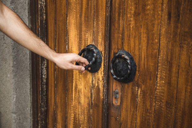 Hand door knocker on old church door