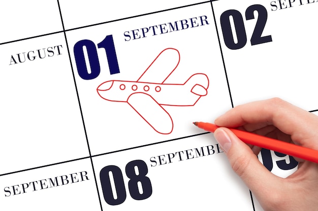 A hand drawing outline of airplane on calendar date 1 September The date of flight on plane