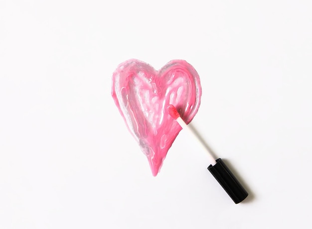 Hand drawn shape of the heart. Sample of pink lip gloss on a white background.