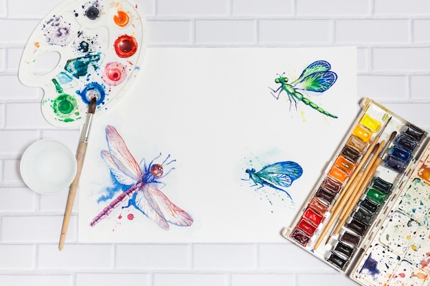 Hand Drawn watercolor Dragonflies Sketch paints paintbrushes palette concept of human creativity