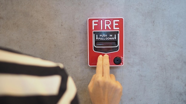 Hand an Emergency of Fire alarm system notifier or alert or bell warning