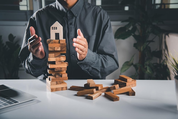 Hand of engineer man protection blocks wood tower