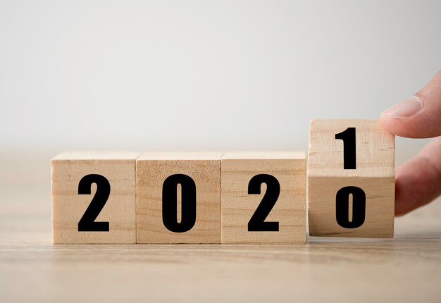 Lanciando a mano blocchi di legno per cambiare gli anni dal 2020 al 2021