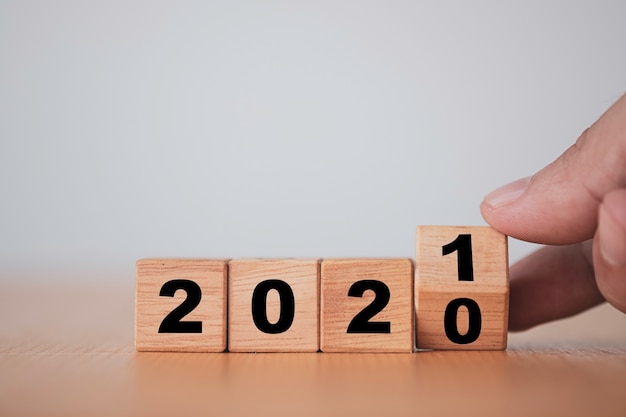 Hand flipping wooden blocks for change year  2020 to 2021