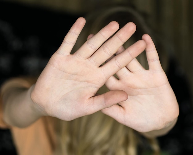 A hand gesture signifying a stop The girl's palm stretched forward