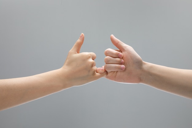 Hand gestures on grey background