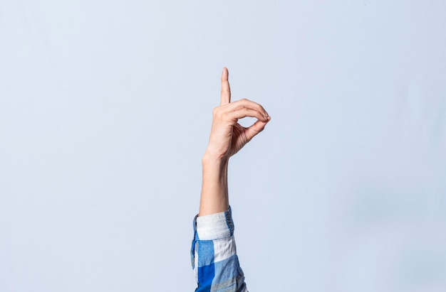 Hand gesturing the letter D in sign language on isolated background Man hand gesturing the letter D of the alphabet isolated Letters of the alphabet in sign language